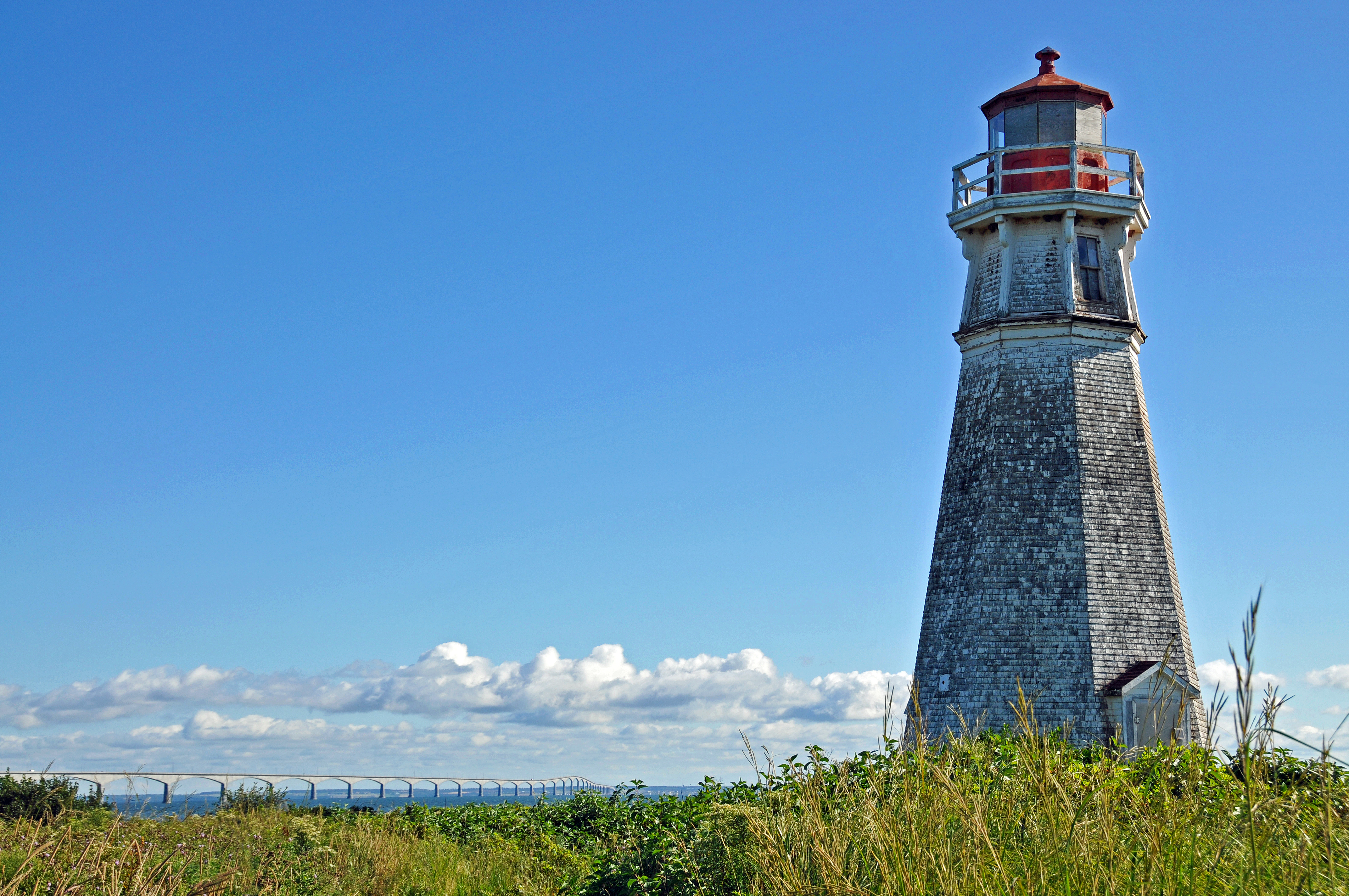 DGJ_8485 - Cape Jourimain Lighthouse looks at the Confederation Bridge.