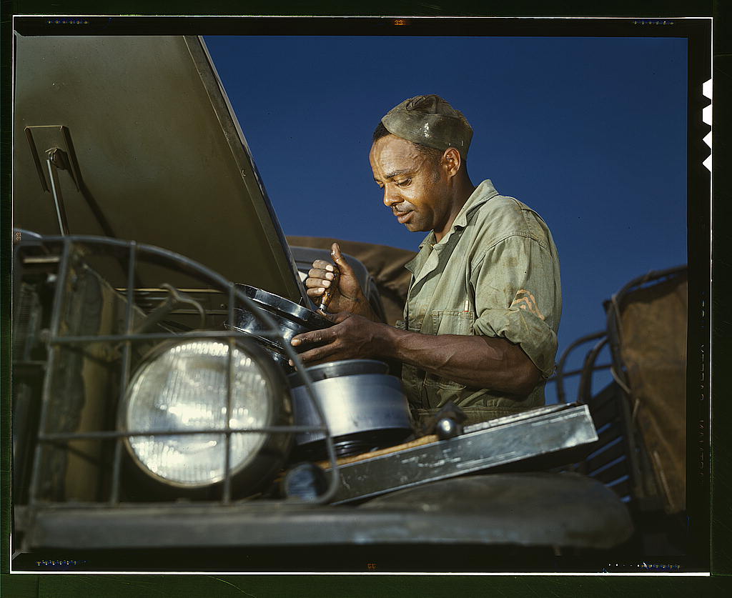 A good job in the air cleaner of an army truck, Fort Knox, Ky. This Negro soldier, who serves as truckdriver and mechanic, plays an important part in keeping army transport fleets in operation  (LOC)