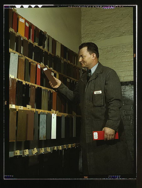 Laboratory worker at the research laboratory at the C & NW RR's 40th Street yard, examining paint samples used on freight cars and coaches of the railroad, Chicago, Ill.  (LOC)