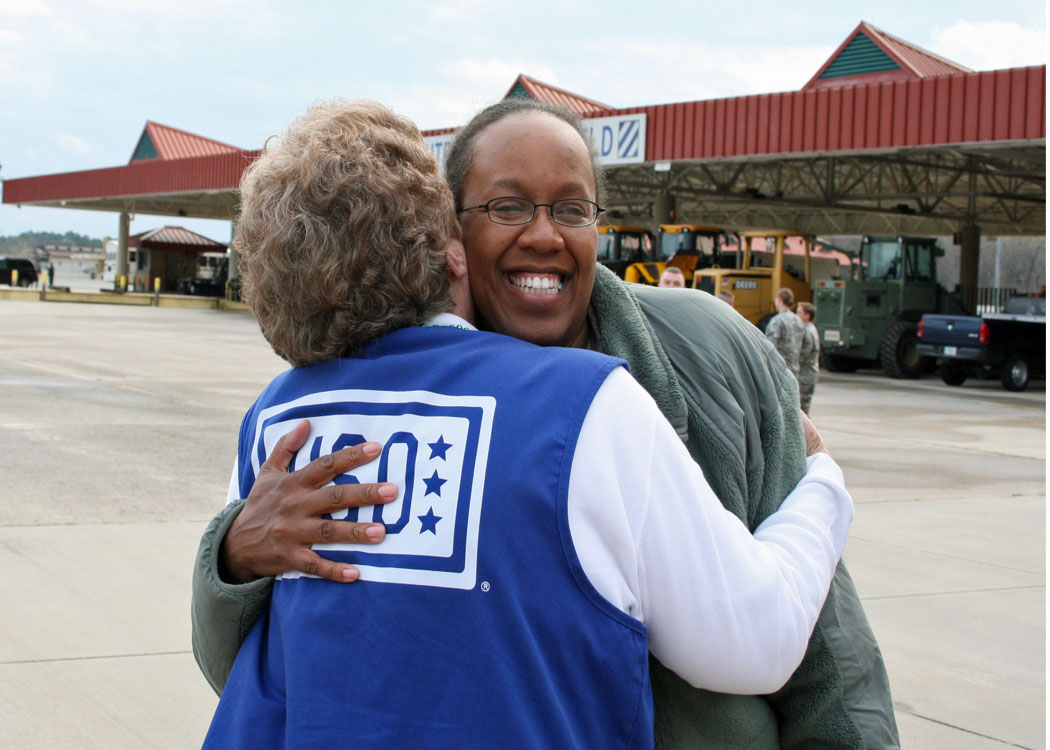 Georgia Guardsman hugs USO representative during welcome home reception after deployment to Afghanistan